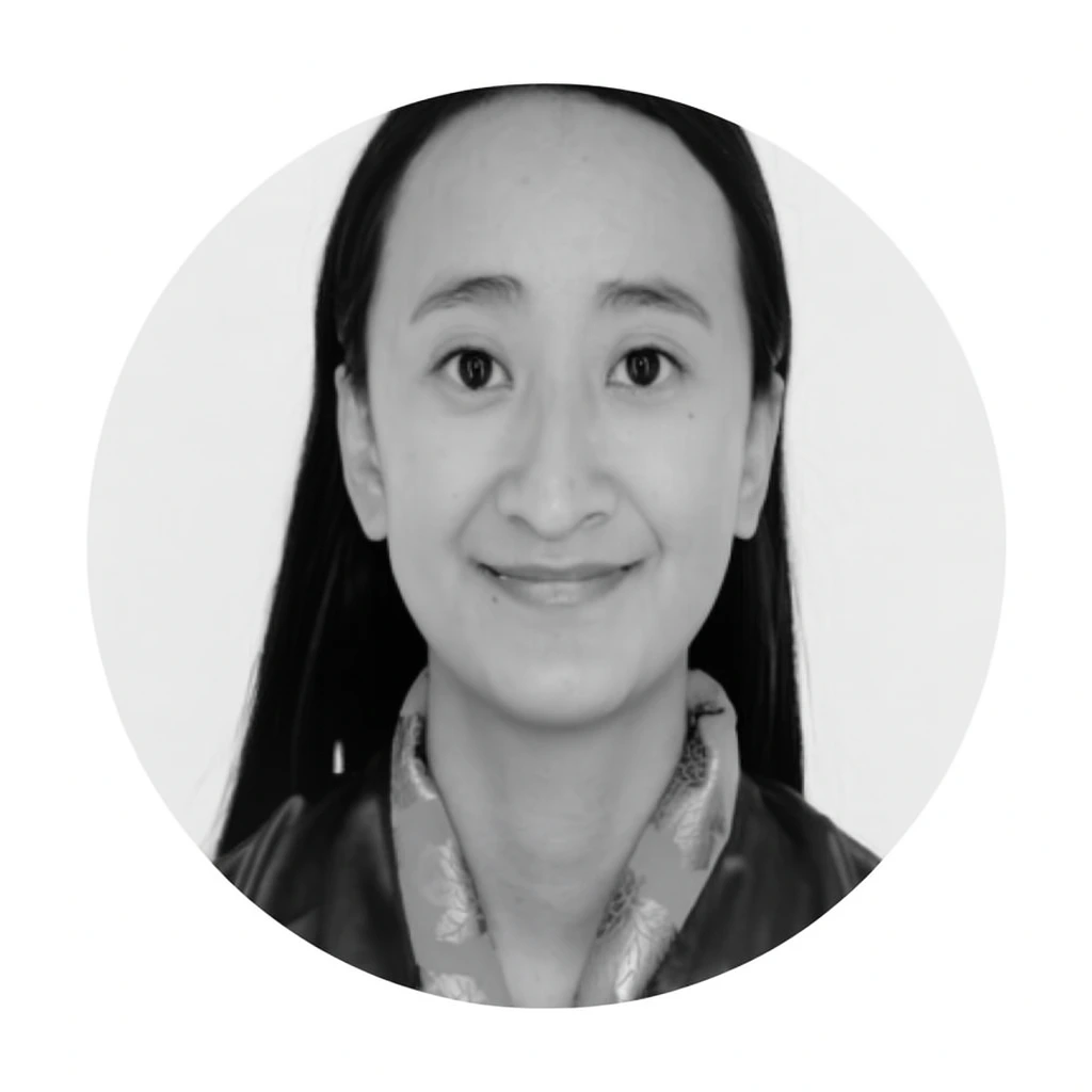 Meet our Babysitters A woman with long dark hair and a patterned scarf smiles at the camera in a black and white portrait photo, capturing the warmth of a cherished cherubs babysitter from Babysitting Perth.