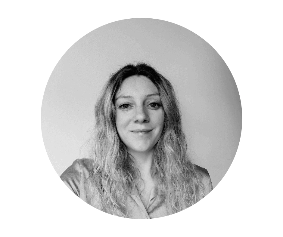 Meet our Babysitters Black and white portrait of a Cherished Cherubs Babysitter with wavy hair, wearing a collared shirt, centered inside a circular frame against a plain background—a cherished cherub captured in timeless elegance.