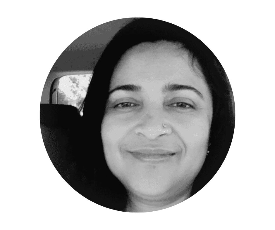 Meet our Babysitters A Cherished Cherubs Babysitter with long dark hair and a nose ring smiles slightly while sitting in a car, captured in black and white—a timeless portrait by Cherished Cherubs.