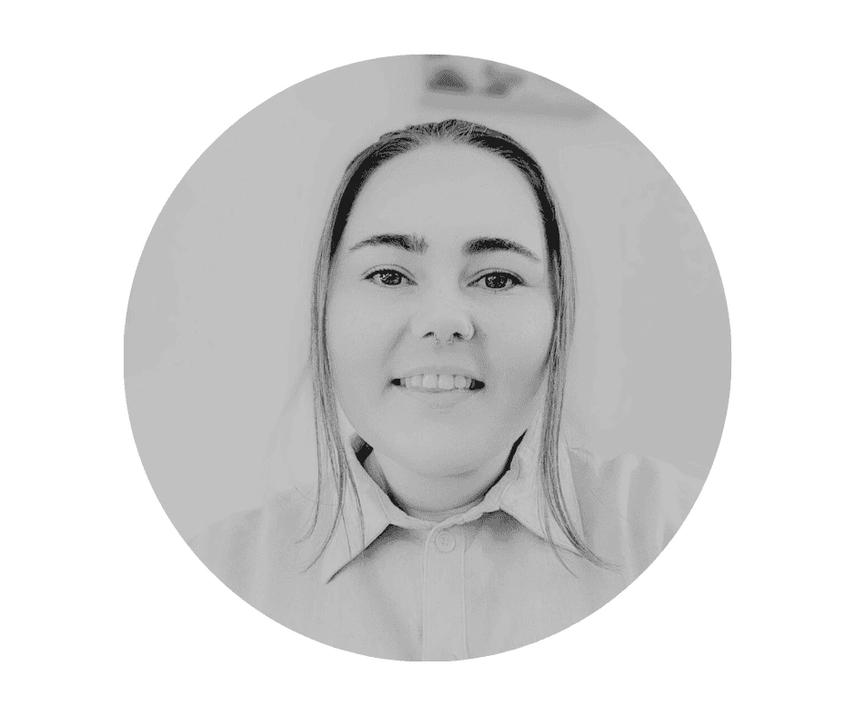 Meet our Babysitters A Cherished Cherubs Babysitter with straight hair and a collared shirt smiles at the camera; the black-and-white photo, cropped in a circular frame, captures the warmth of cherished cherubs.