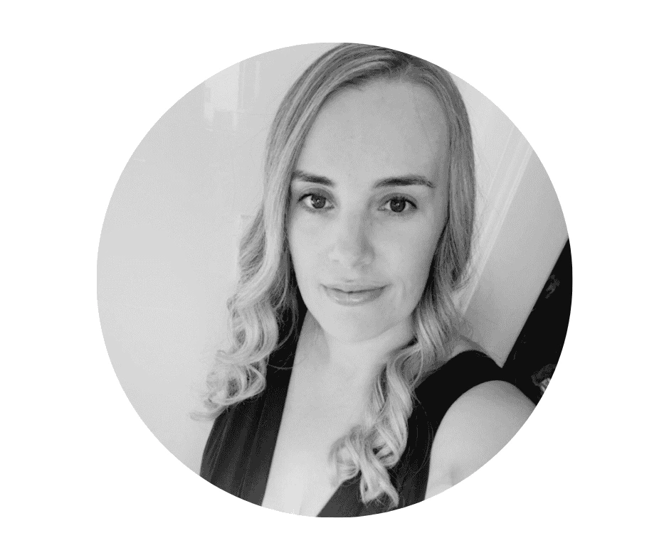 Meet our Babysitters Black and white portrait of a Cherished Cherubs Babysitter with long, wavy hair, wearing a sleeveless top, looking at the camera with a slight smile—capturing the timeless elegance of Cherished Cherubs.