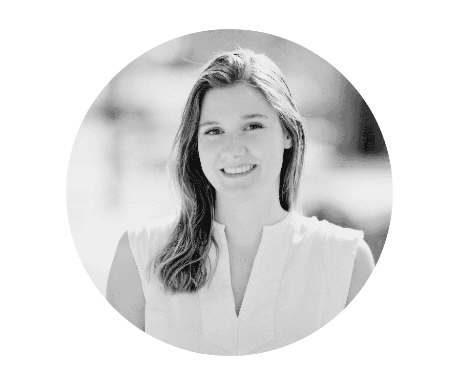 A Cherished Cherubs Babysitter with shoulder-length hair, wearing a sleeveless light top, is smiling at the camera in a black-and-white, circular-cropped Cherished Cherubs portrait.