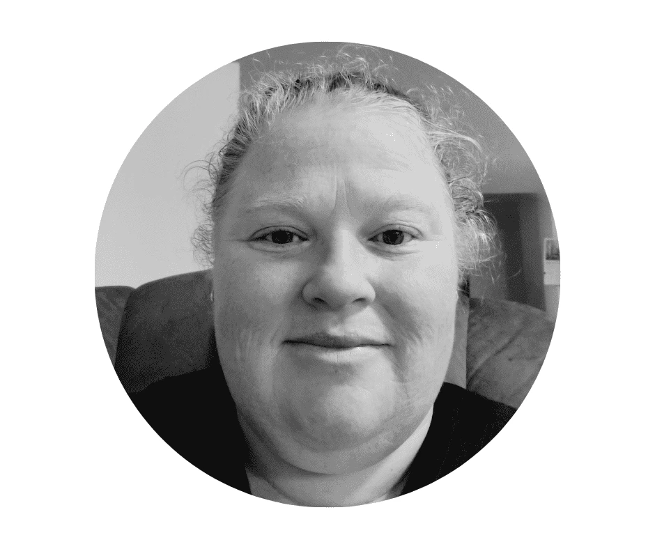 Black and white portrait photo of a Cheerished Cherubs Babysitter with light hair pulled back, looking directly at the camera with a neutral expression—a timeless style reminiscent of Cherished Cherubs photography.