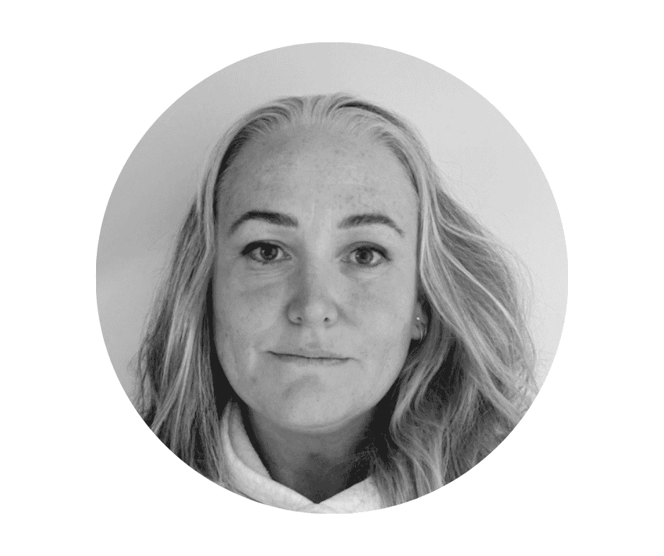 Black-and-white portrait photo of a Cherished Cherubs Babysitter with long, wavy hair and a neutral expression, facing the camera against a plain background within a circular frame—a timeless image by Cherished Cherubs.